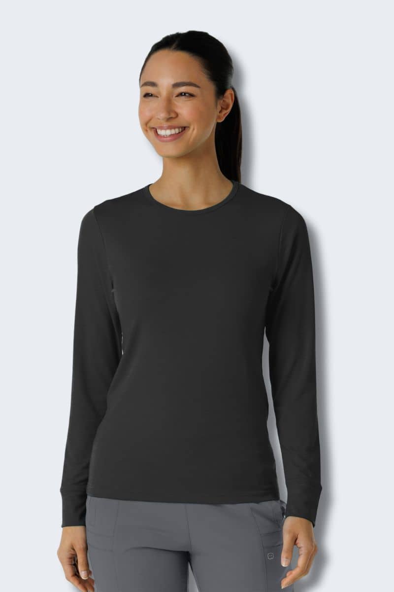 Woman wearing a black long-sleeve shirt and gray pants against a light gray background. Wink 2189 Style shirt