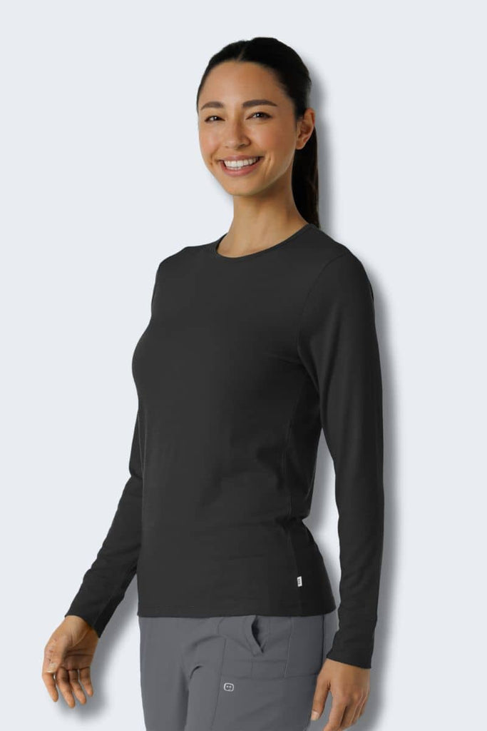 Woman wearing a black long-sleeve shirt and gray pants against a white background. Wink 2189 Style shirt