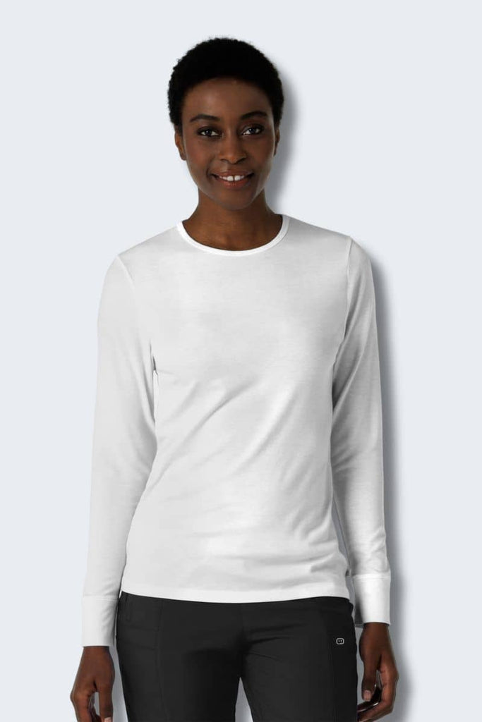 Person wearing a white long-sleeve shirt and black pants on a white background