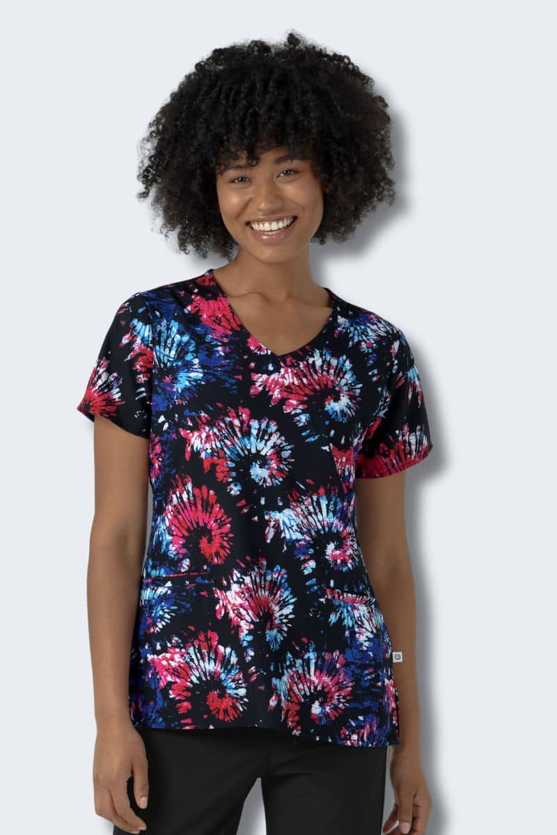 Person wearing a colorful tie-dye shirt on a plain background