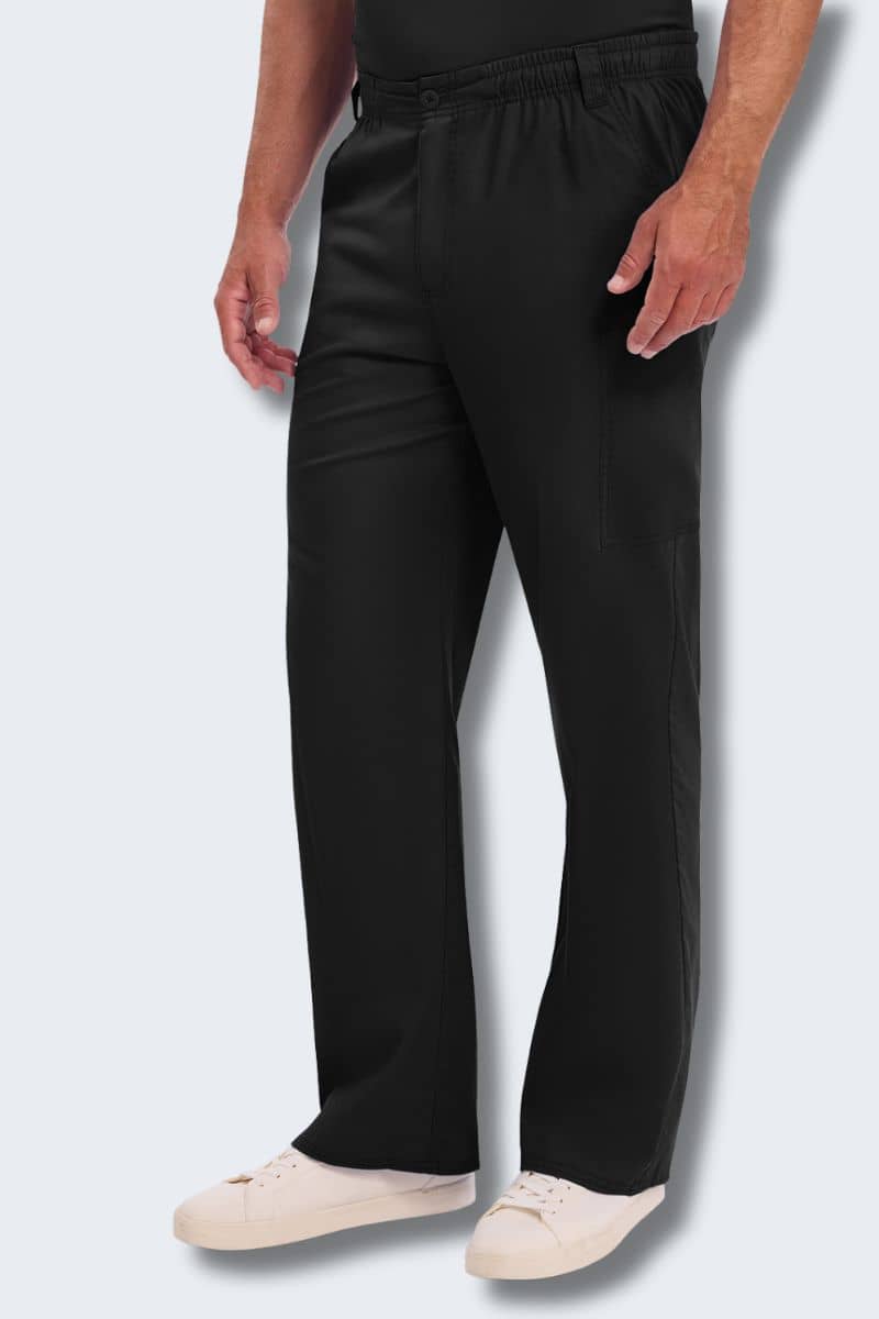 Person wearing black pants and white shoes on a light gray background. Dickies 81006 Men's Cargo Scrub Pants Black