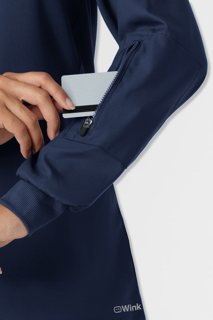 Navy blue jacket with a zipper being pulled open on a white background, featuring the Wink brand. Wink Boundless 8151