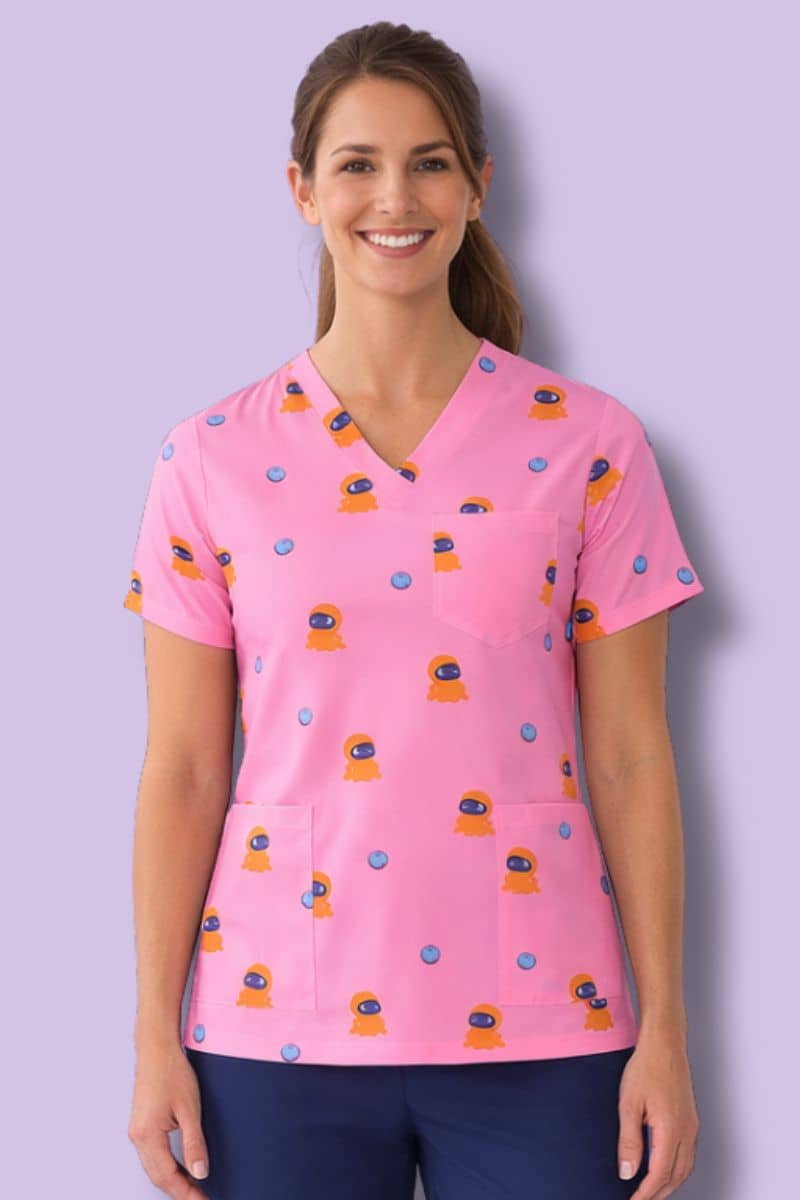Woman wearing a pink scrub top with a pattern against a purple background. Hospitals United For Sick Kids Unisex Blip Scrubs