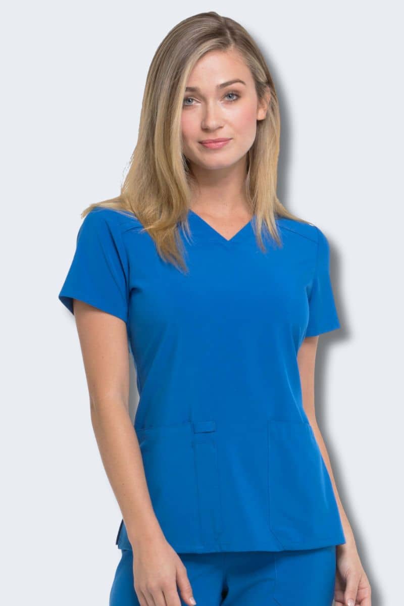 Woman wearing a blue scrub set against a white background. Dickies CK615
