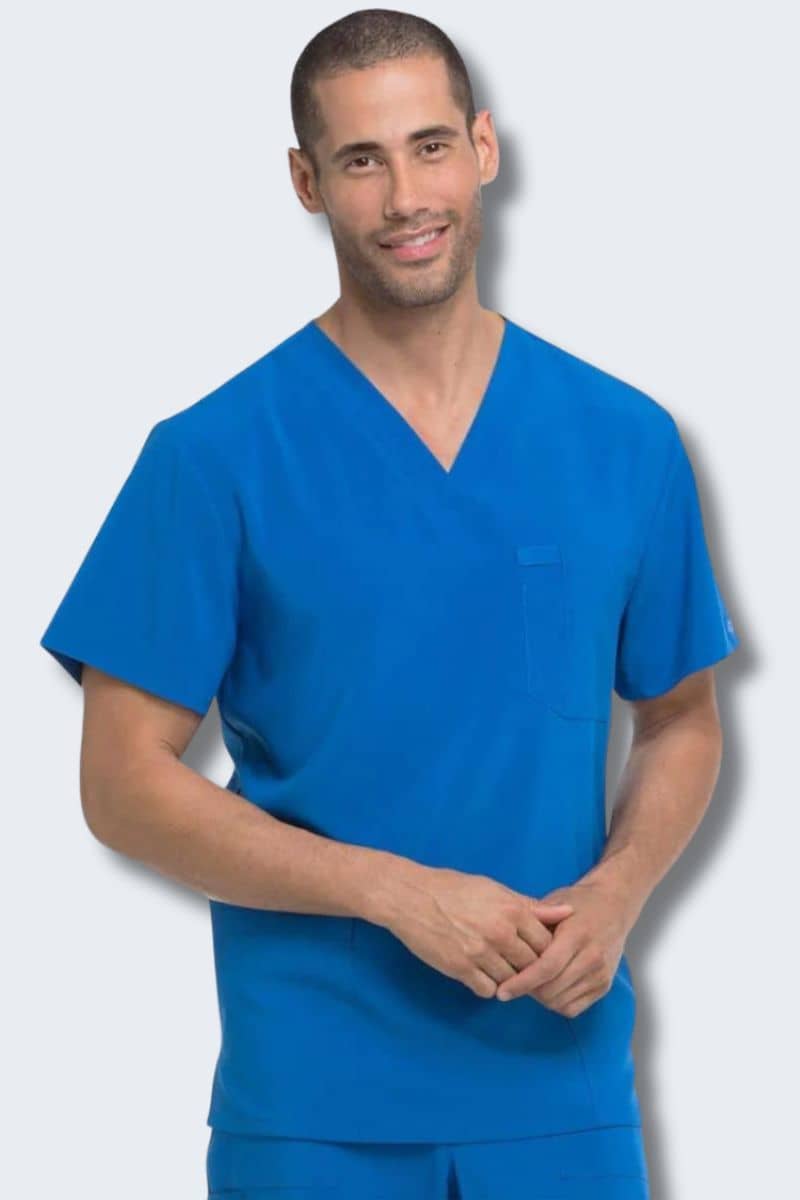 Man wearing a blue scrub set against a light gray background. Dickies DK645