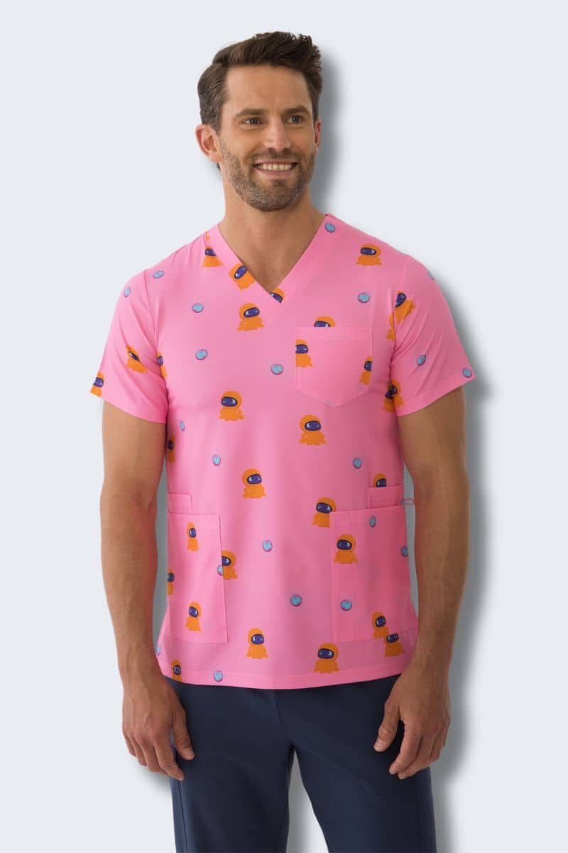 Man wearing a pink scrub top with colorful patterns on a white background. Hospitals for Sick Kids Blip Print Scrubs infectious.com.au