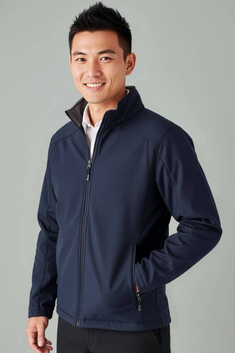 Man wearing a navy blue jacket against a gray background. Biz Collection J307M