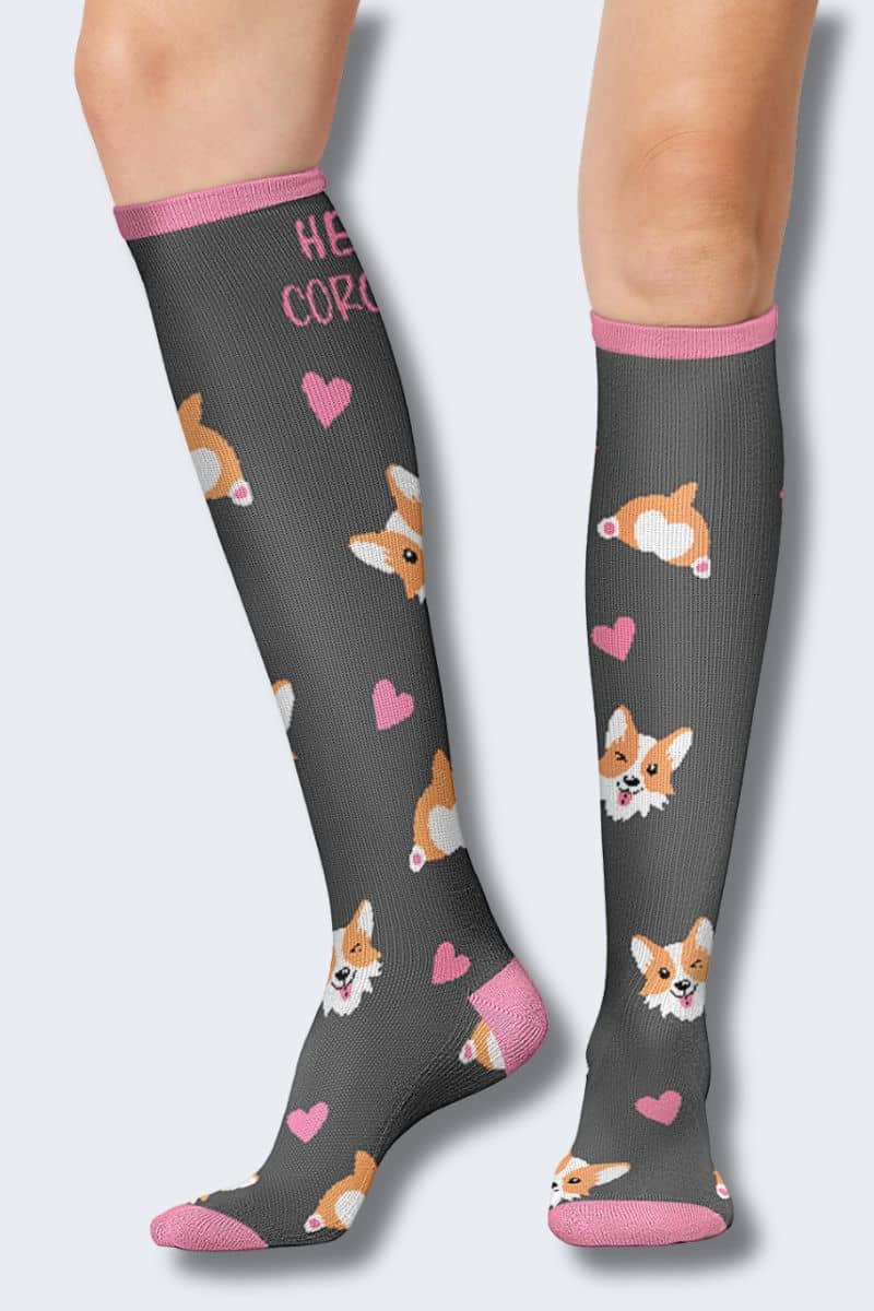 Knee-high socks with corgi pattern and 'Hello Gorgeous' text on a gray background. Printsupport Cherokee