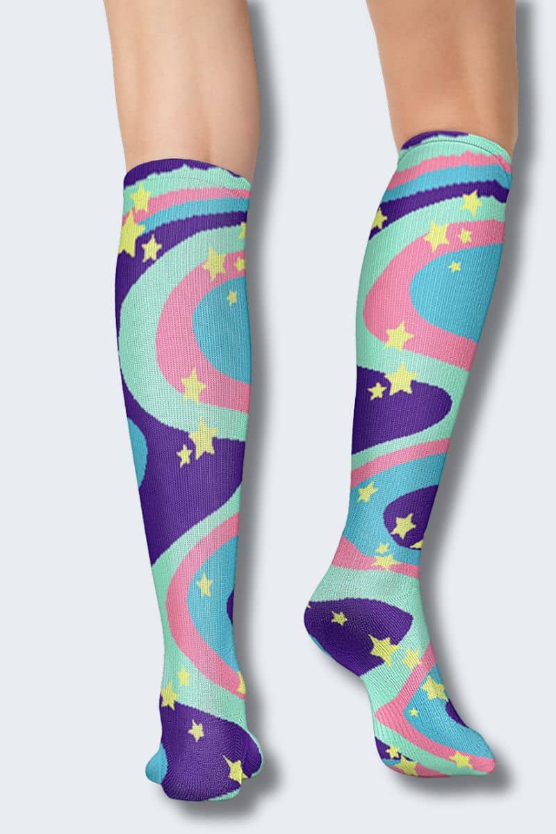 Colorful knee-high socks with star and rainbow pattern on a white background