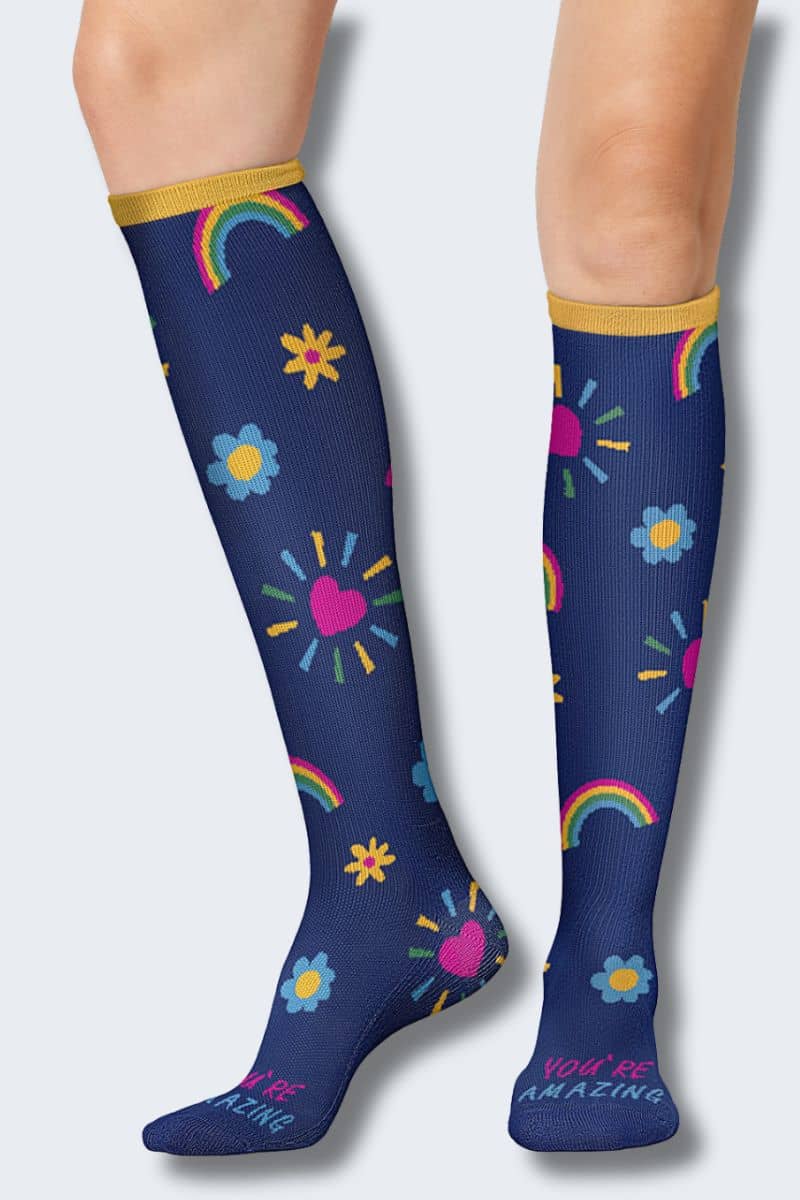 Navy blue knee-high socks with colorful patterns on a white background. Cherokee Printsupport You're Amazing