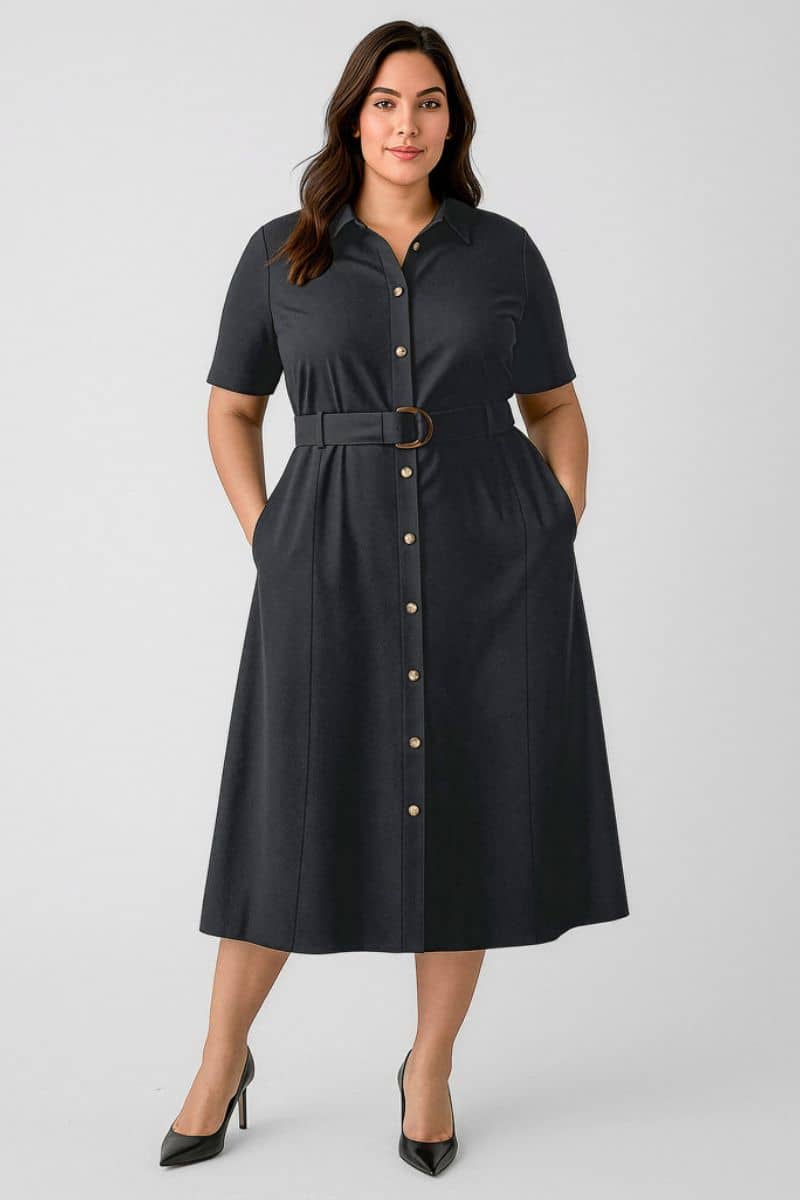 Woman wearing a black button-up dress with a belt on a white background